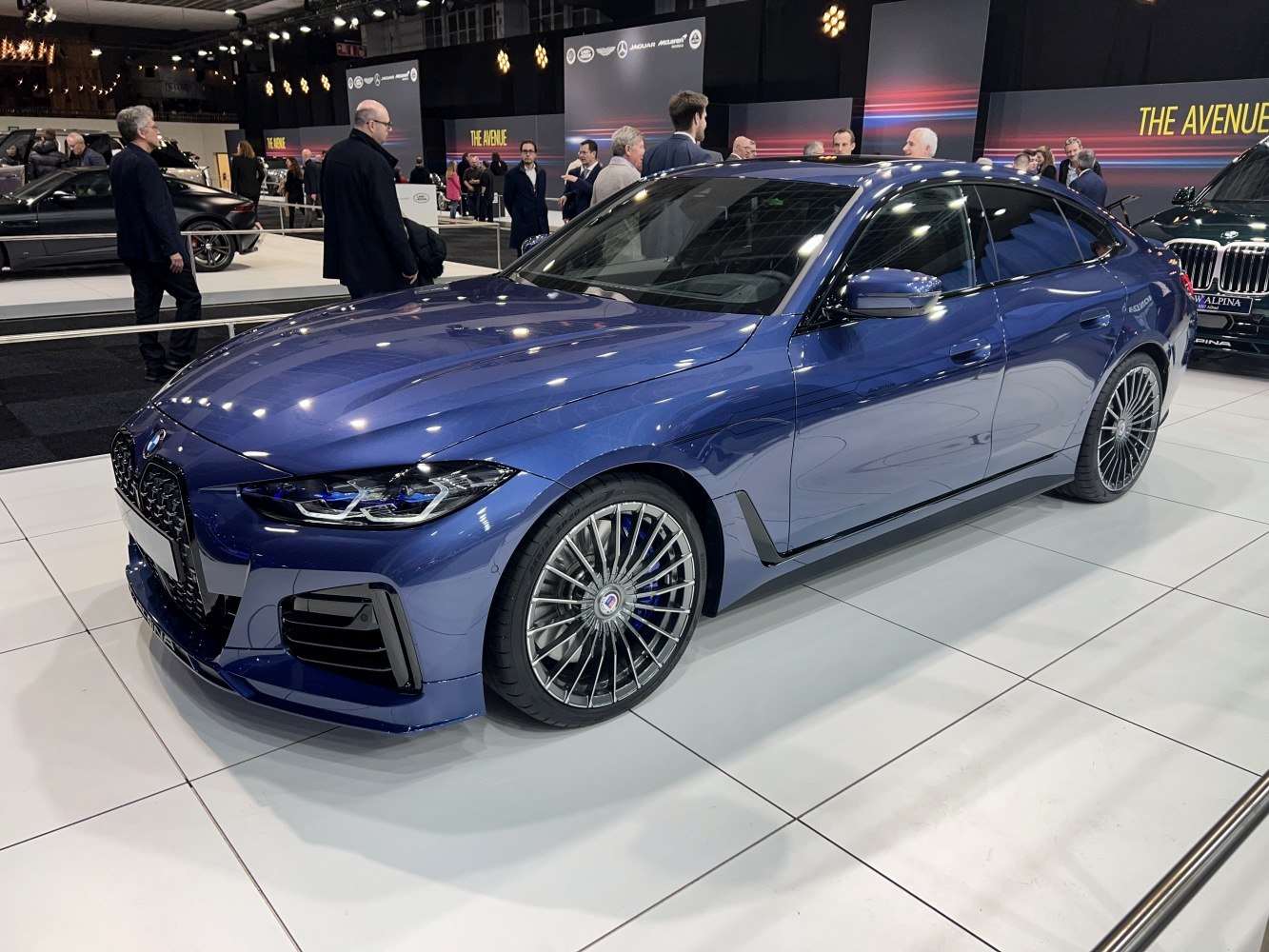 Blue Gran Coupe with sharp headlights and multi-spoke Alpina wheels