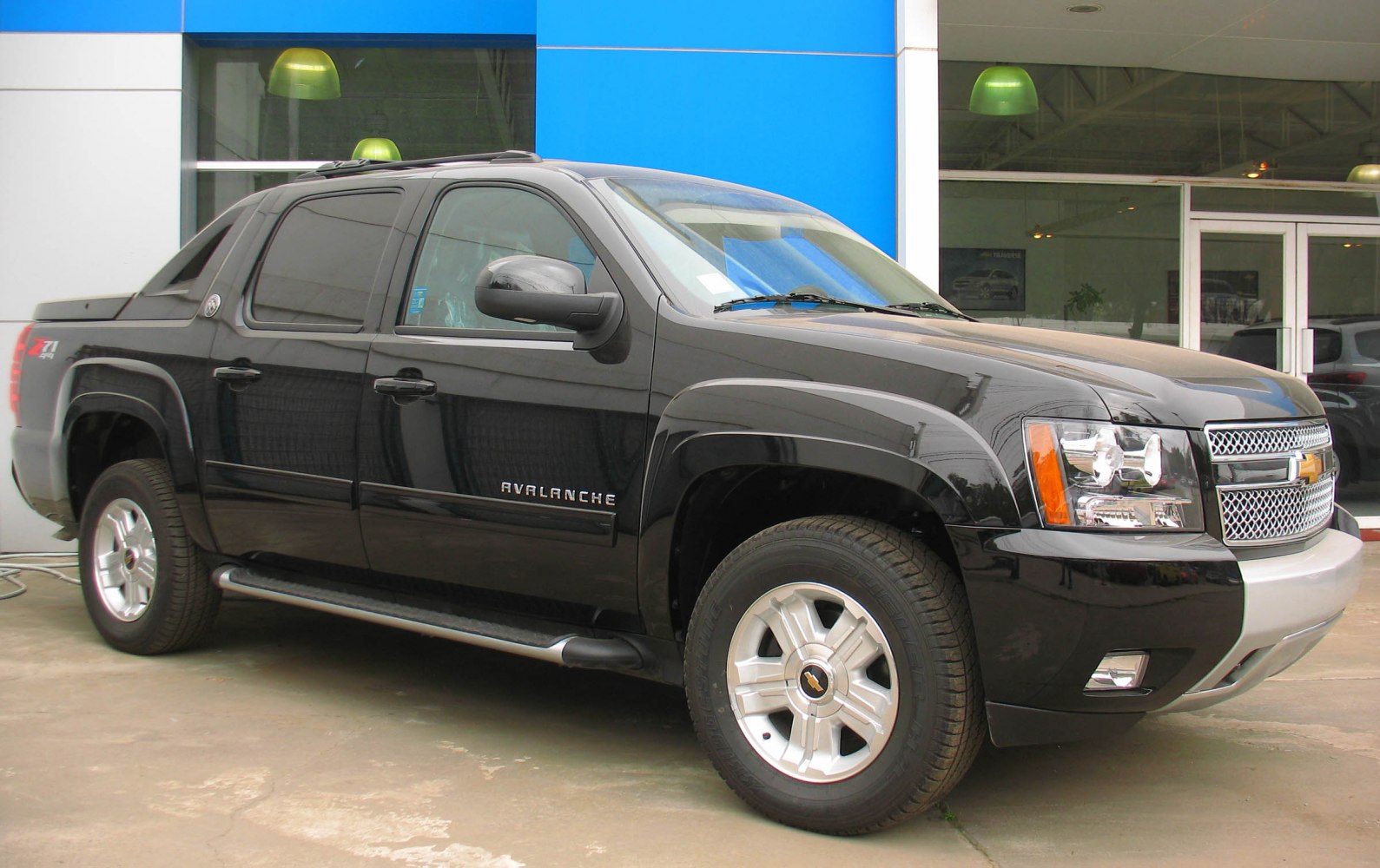 Black pickup truck front side profile with rugged body and distinctive grille