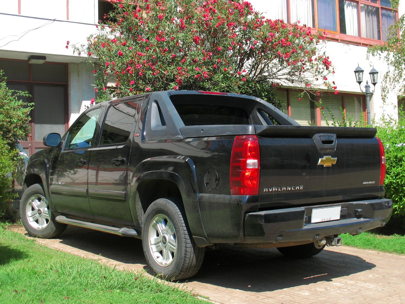 Rear and side view of black four-door pickup with distinct tailgate and rear window.