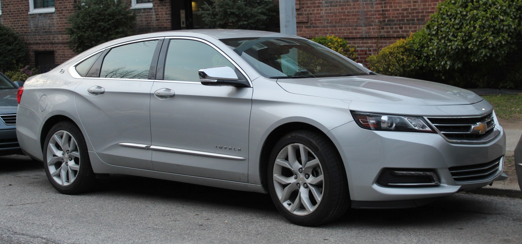 Silver sedan with sleek headlights and chrome accents from front-side