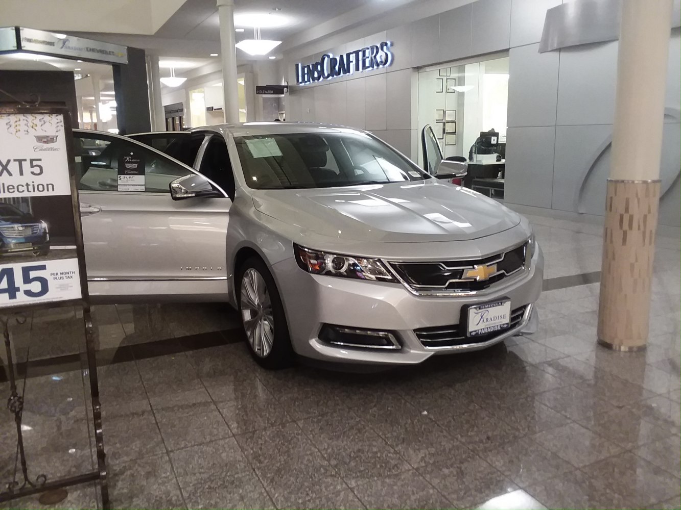 Front and side view of a sedan with open doors