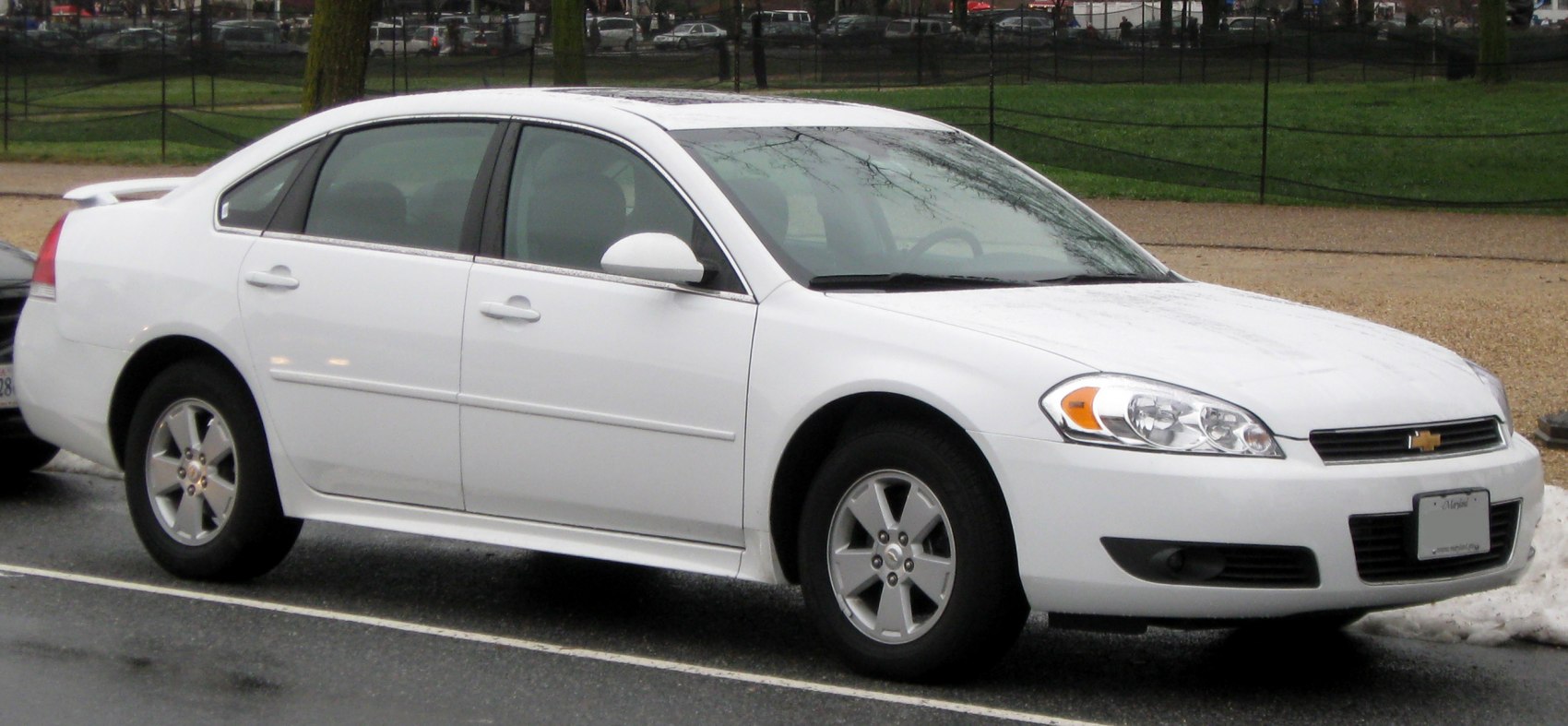 White full-size sedan side view with alloy wheels and sleek body lines