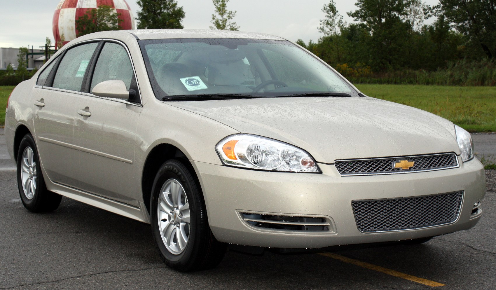 Front and side view of sedan with mesh grille and alloy wheels