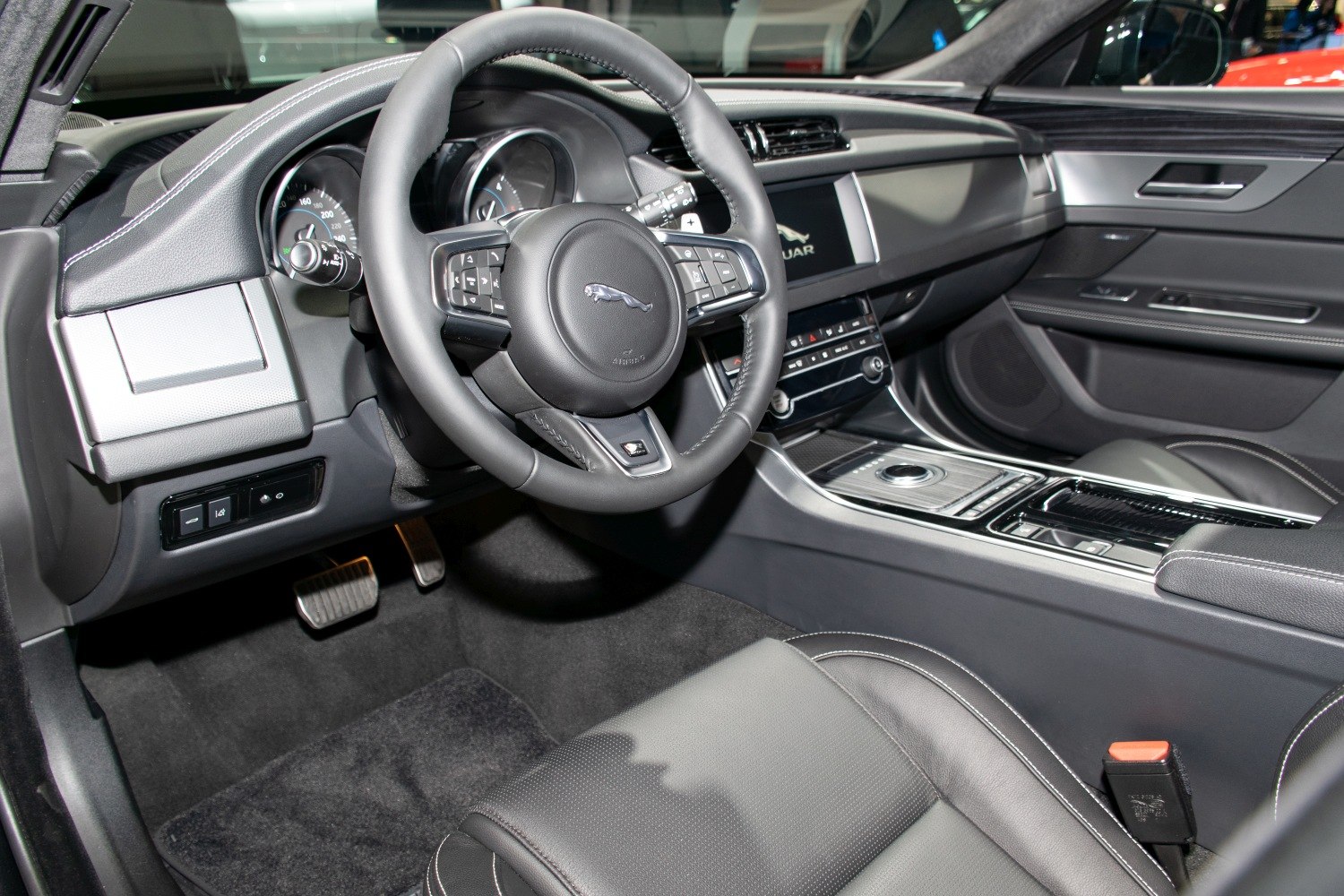 Modern luxury car interior with advanced steering wheel and dashboard