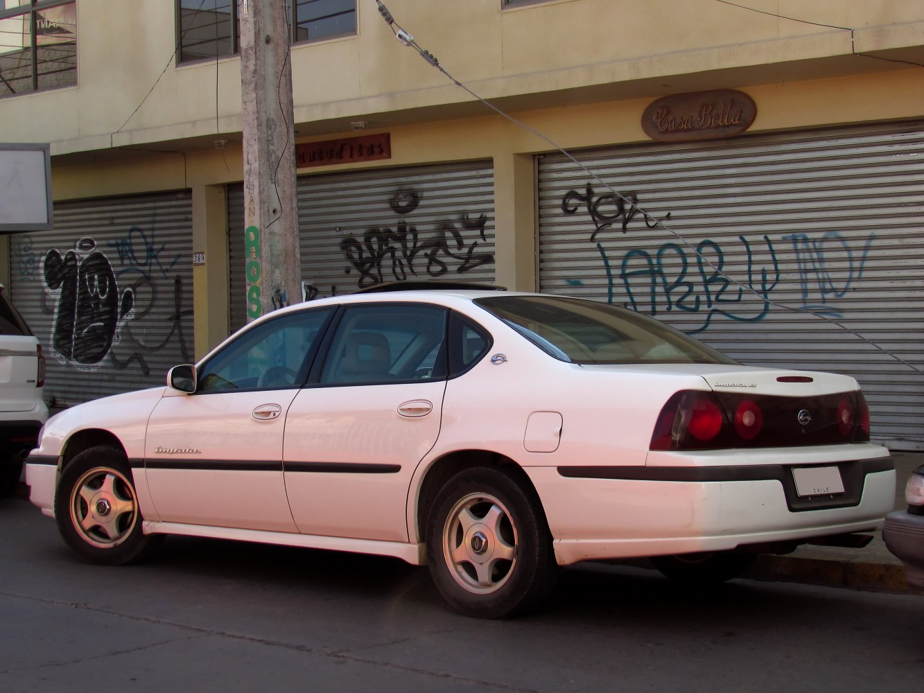 Side profile of a classic four-door sedan with distinctive taillights and alloy wheels.