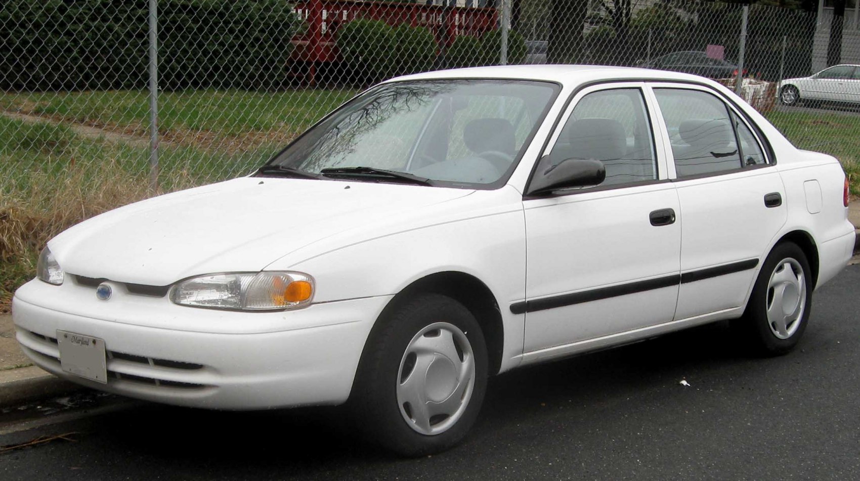 Front side view of a four-door sedan with hubcaps