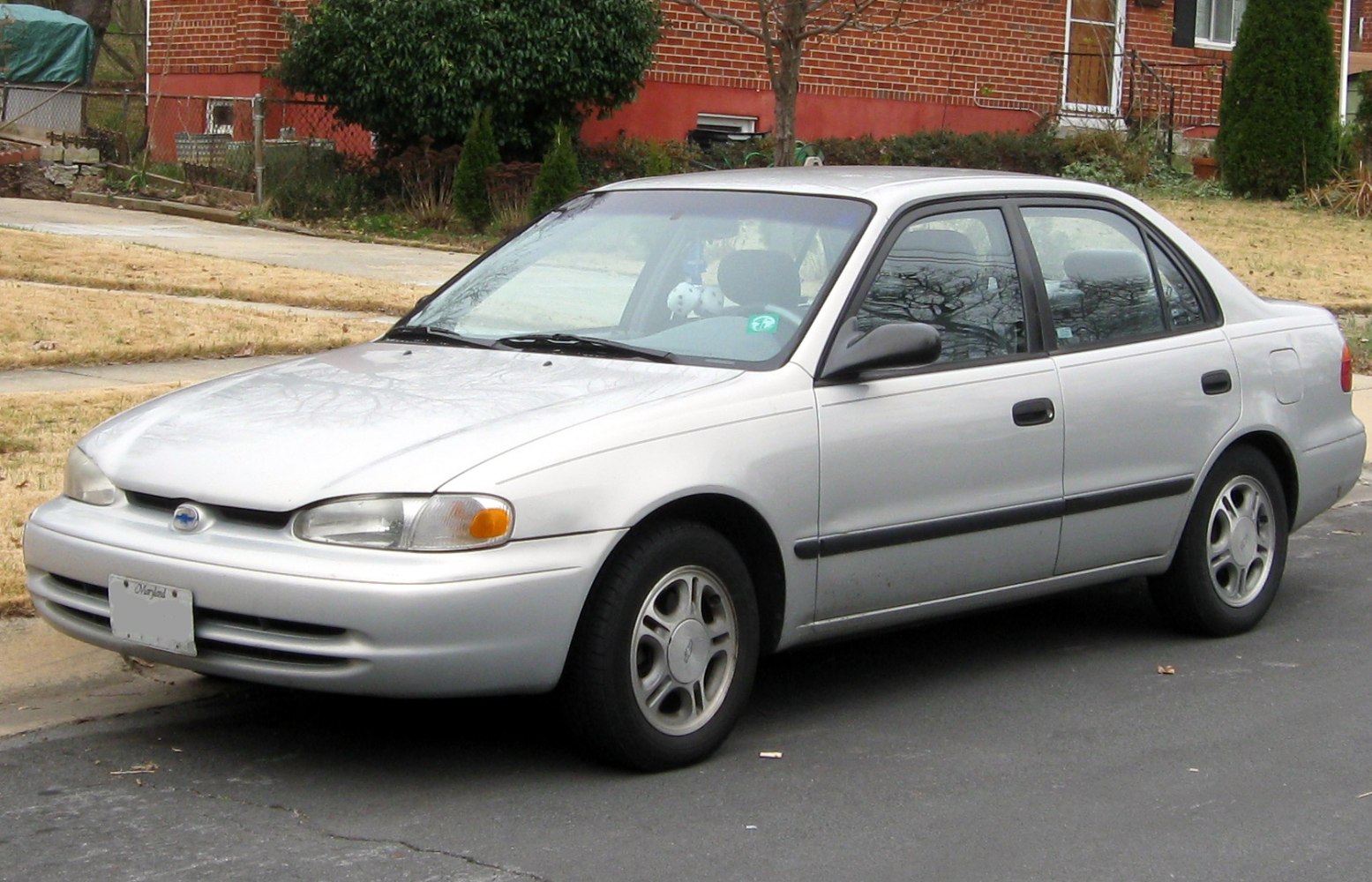 Compact sedan with rounded headlights and five-spoke wheels