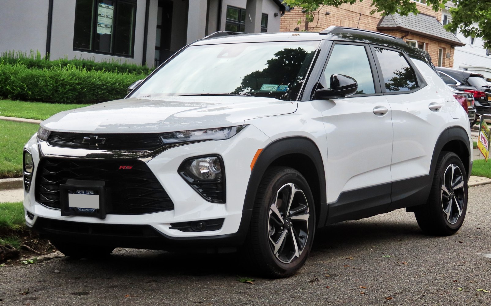 Front and side view of a white SUV with black accents and alloy wheels