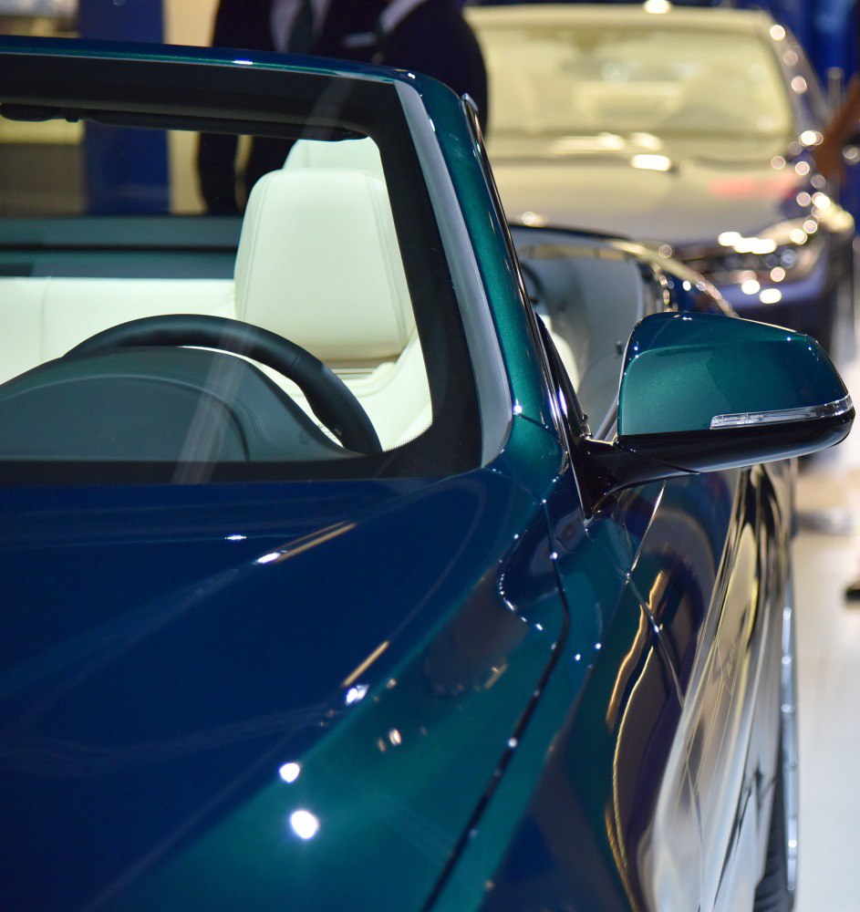 Convertible white leather seats and side mirror close-up