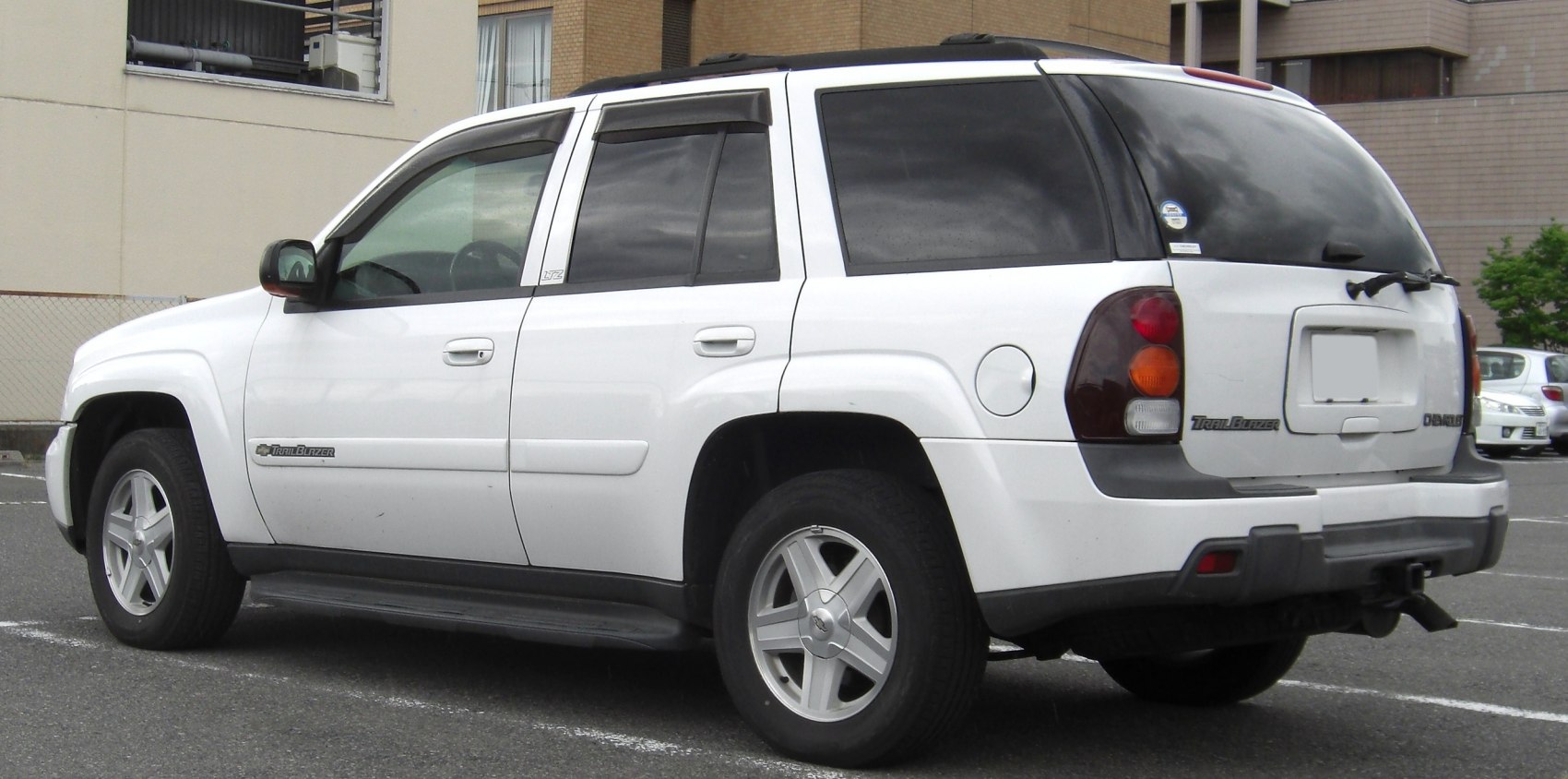 White SUV with side and rear profile, tinted windows, distinct rear lights