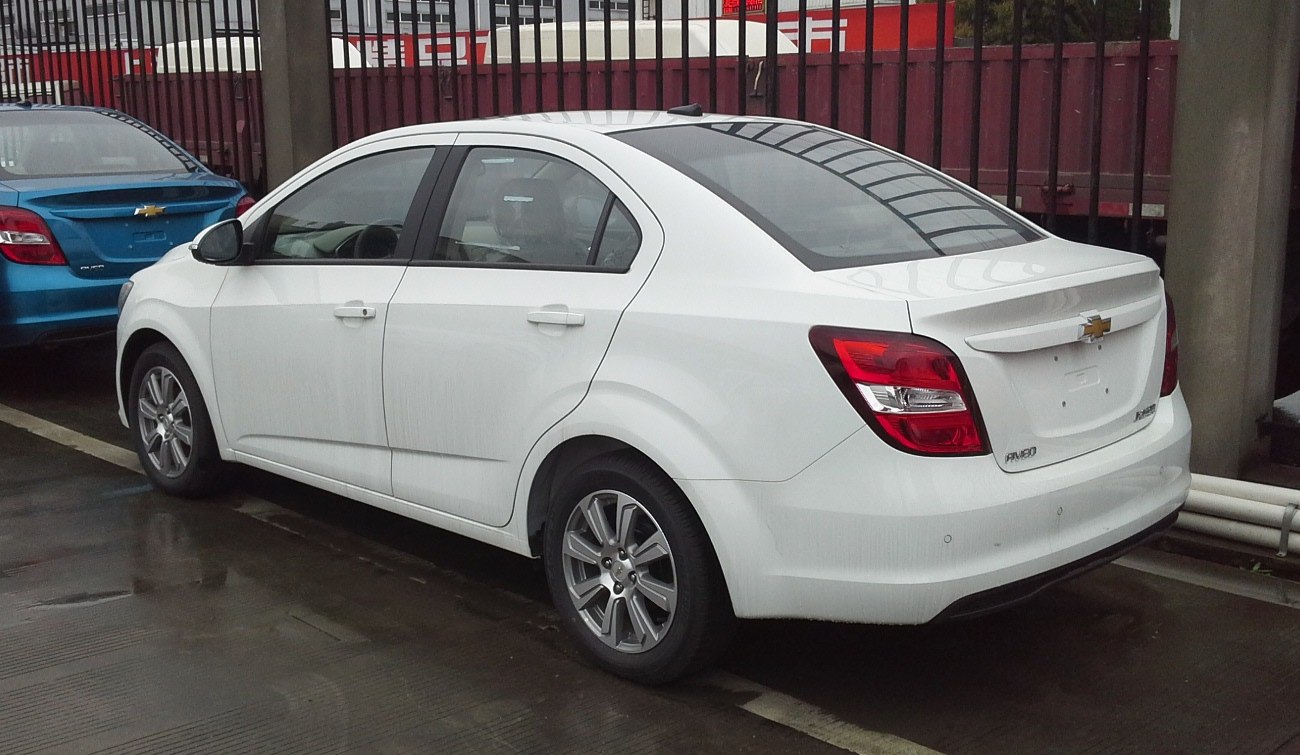 Rear and side view of compact sedan with distinct tail lights and alloy wheels