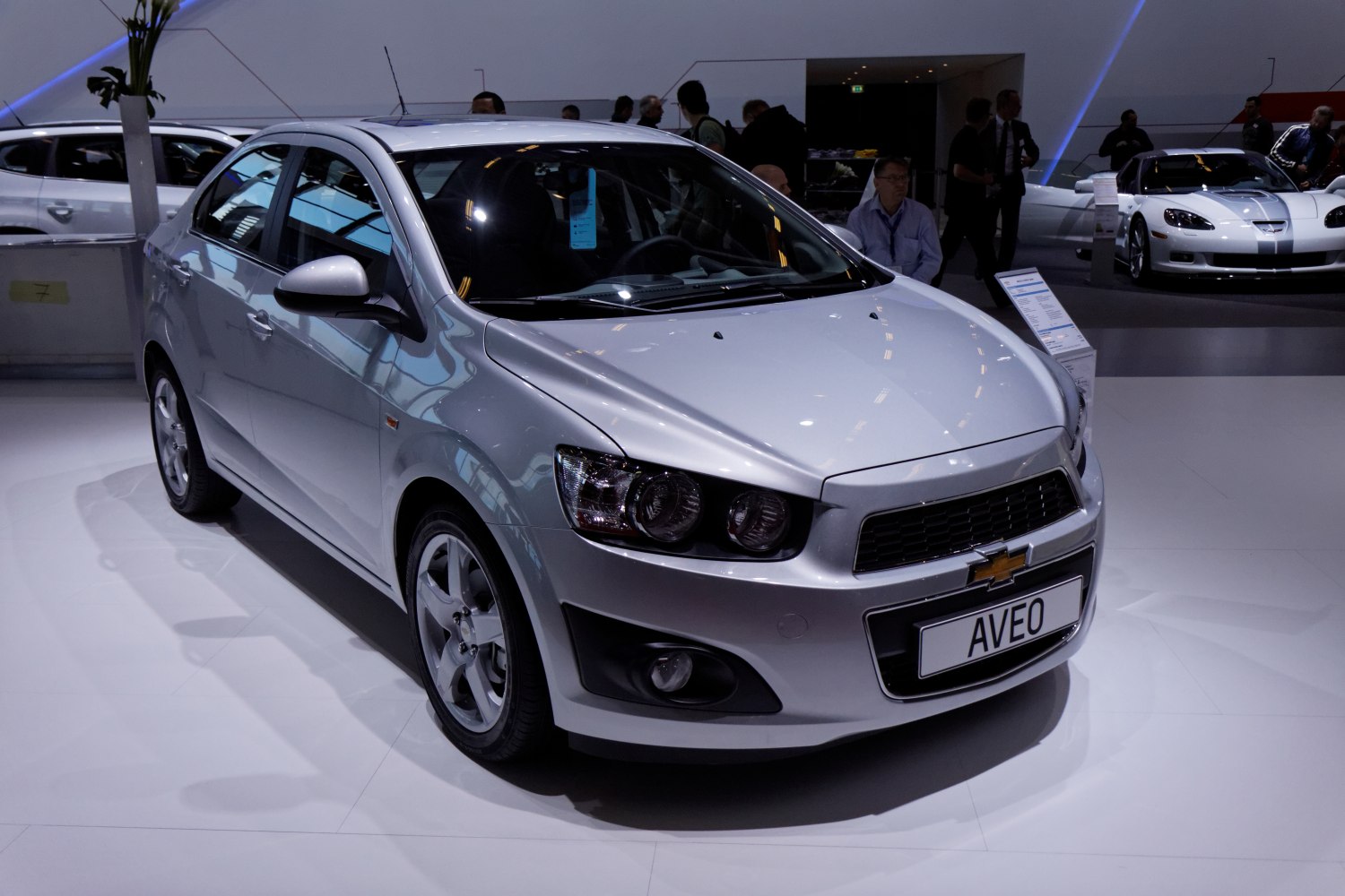 Silver compact sedan front angle with clear headlights and grille