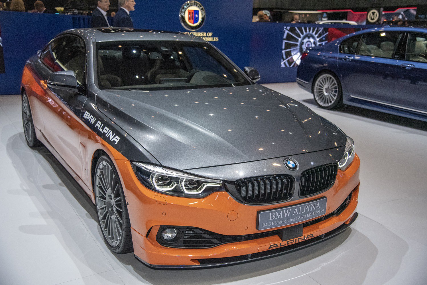 Front view of a sports coupe with aggressive headlights and distinct two-tone gray and orange paint