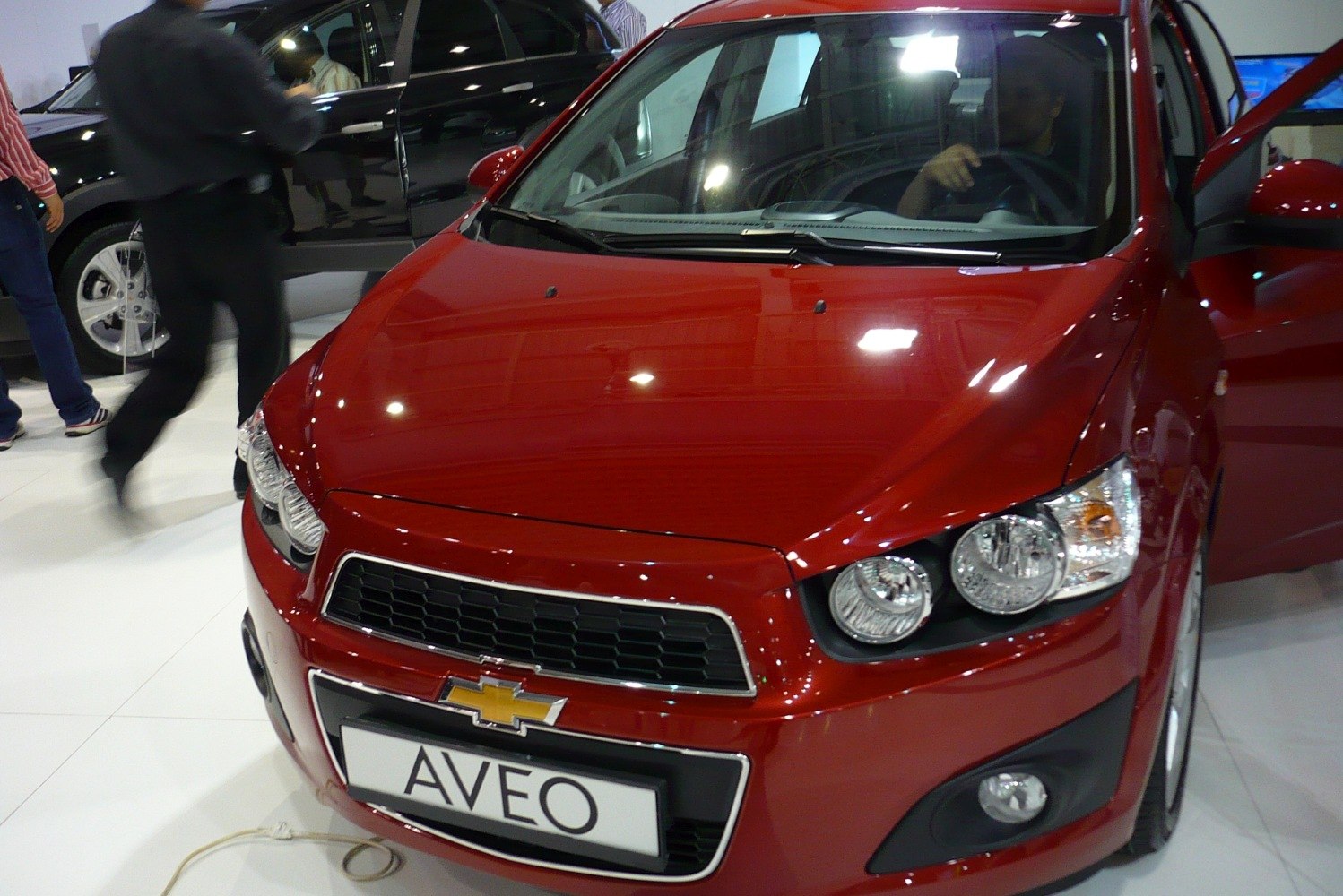 Close-up of front fascia with dual round headlights and honeycomb grille