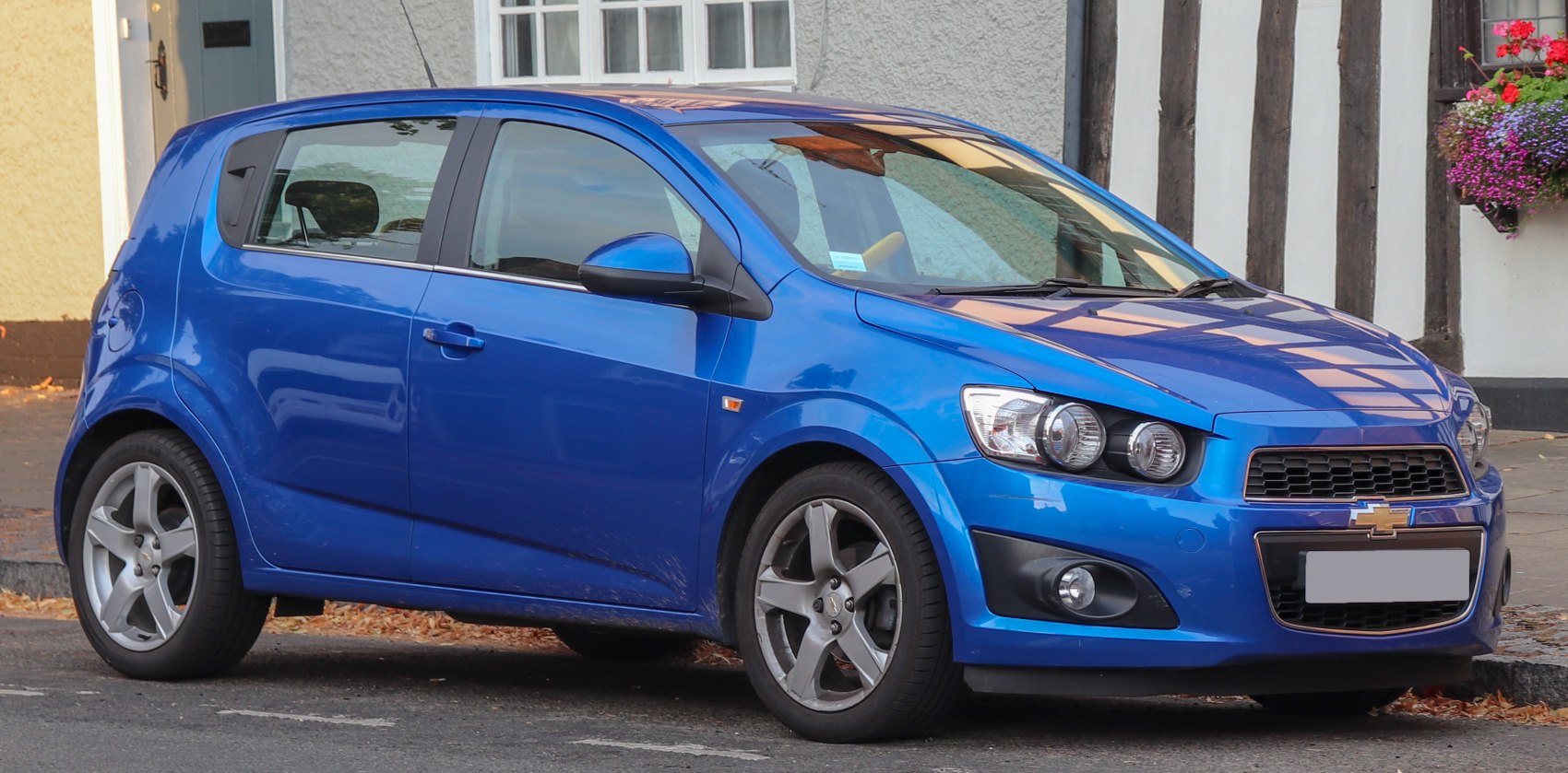 Blue compact hatchback with alloy wheels and modern headlights.