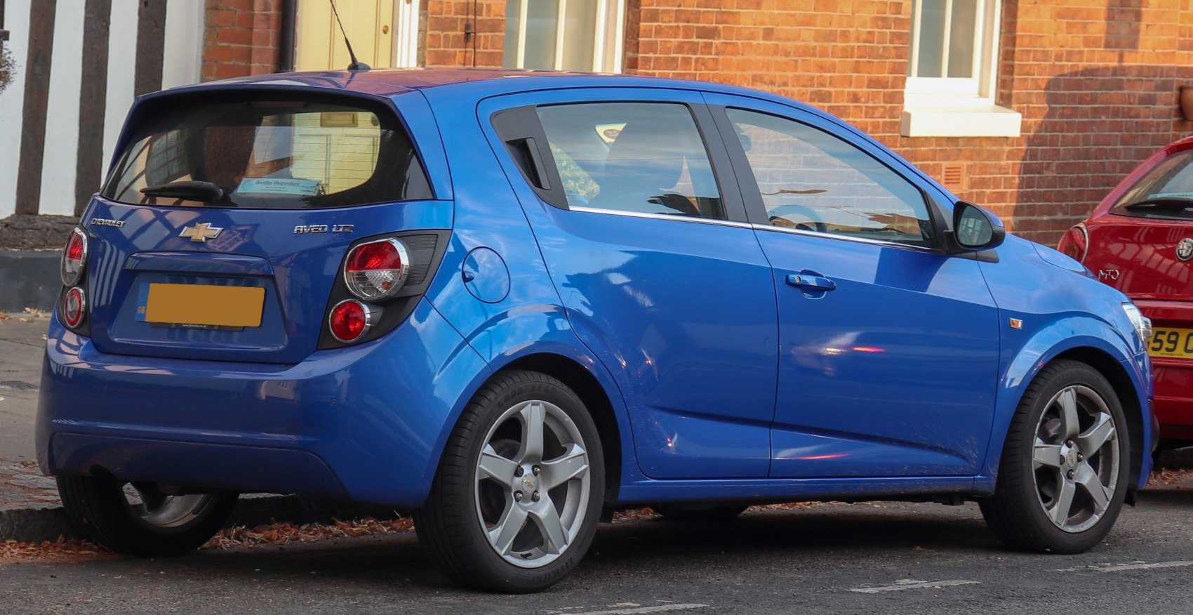 Blue compact hatchback rear and side view with round taillights