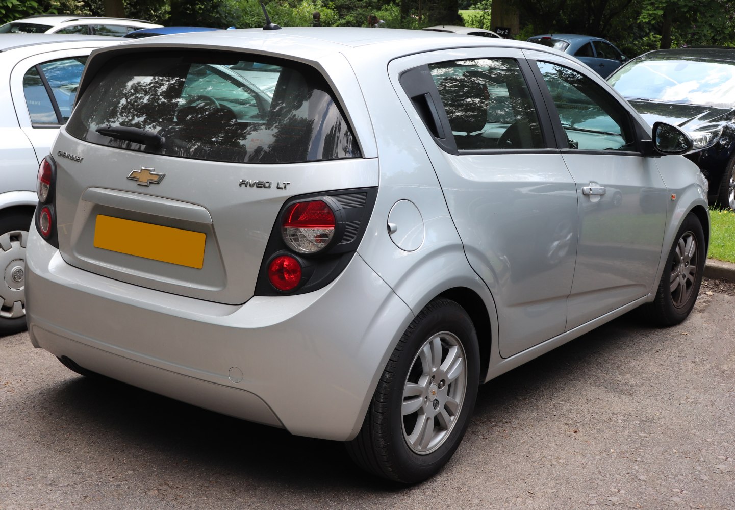 Rear hatchback view with distinct round tail lights and silver alloy wheels