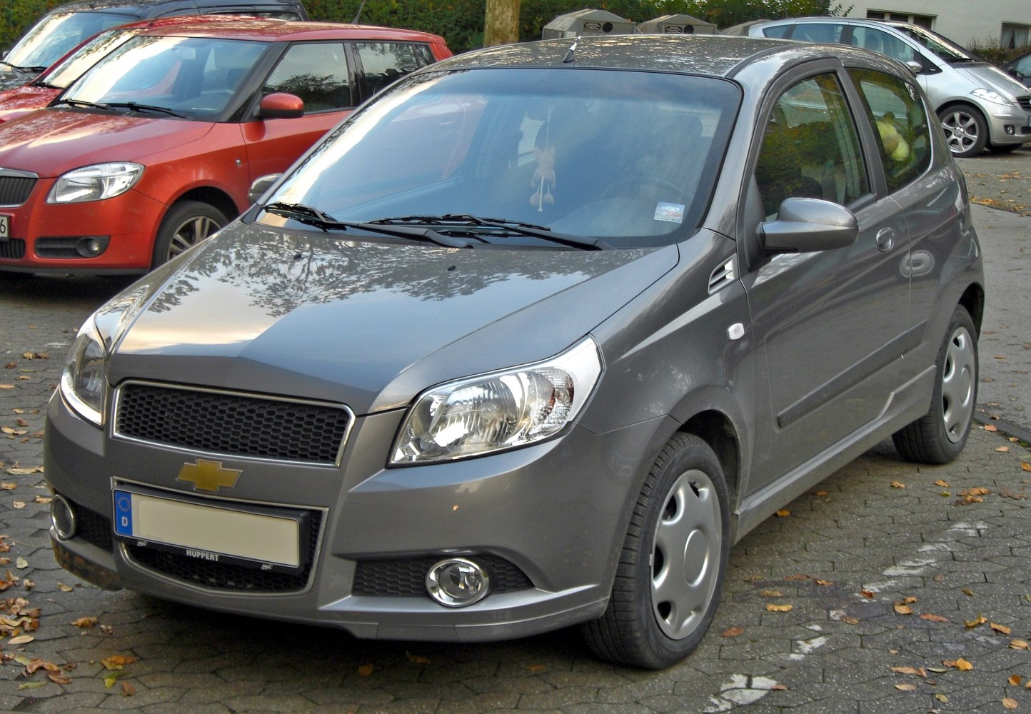 Front and side view of compact hatchback car with facelift design.