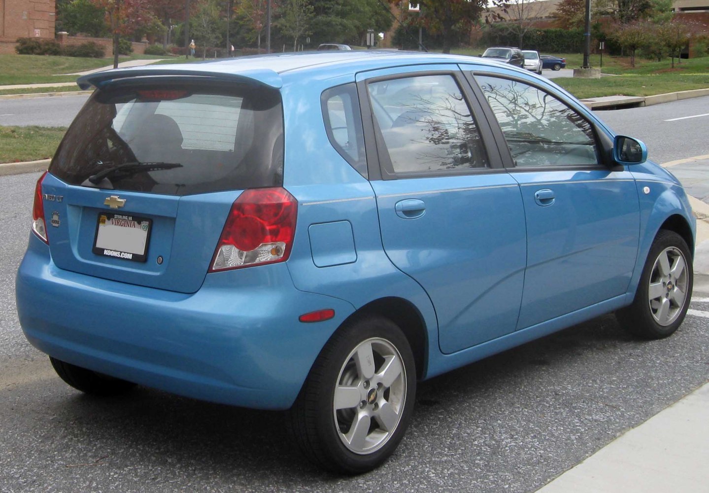 Blue compact hatchback rear and side view on street.