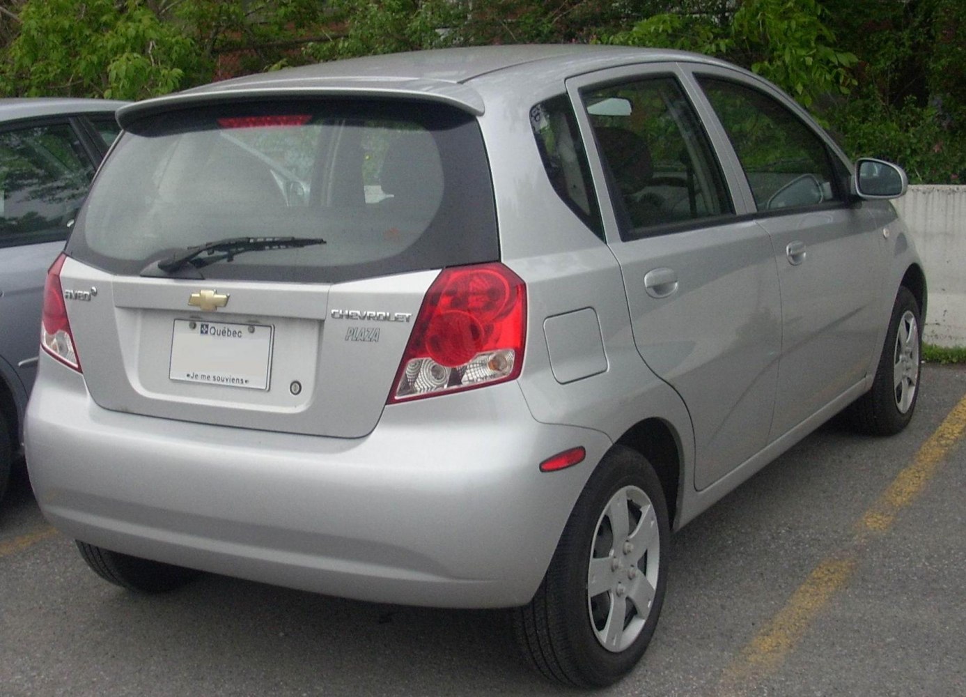 Rear view of a compact five-door hatchback with tail lights and rear windshield wiper