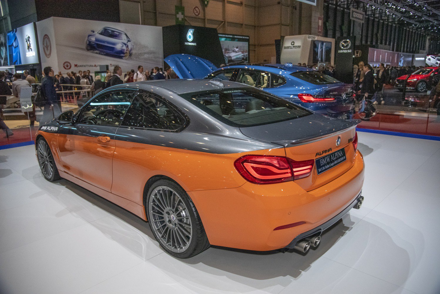 Rear view of dual tone coupe with quad exhaust and sporty wheels