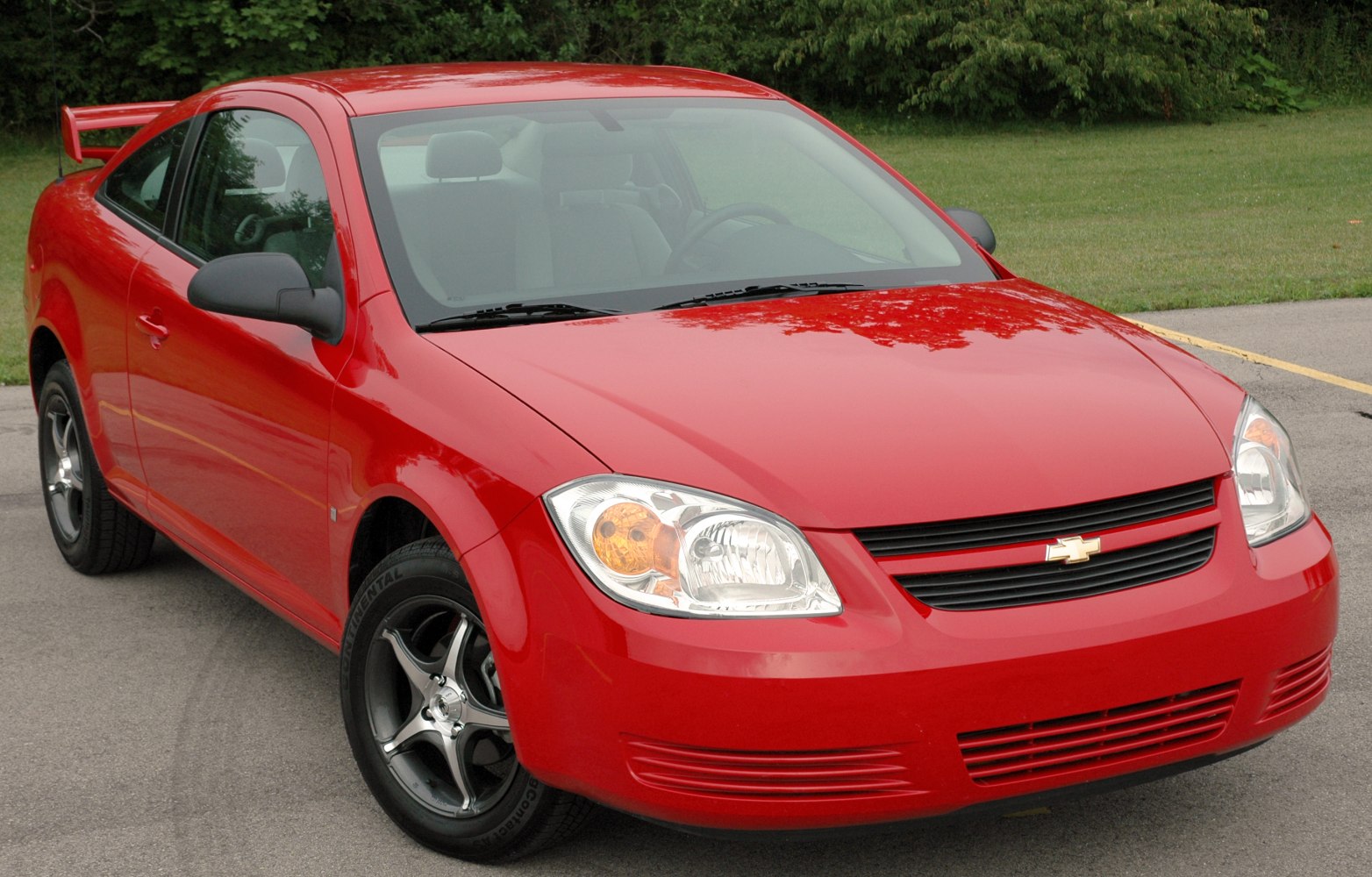 Front view of a compact coupe with alloy wheels and rear spoiler