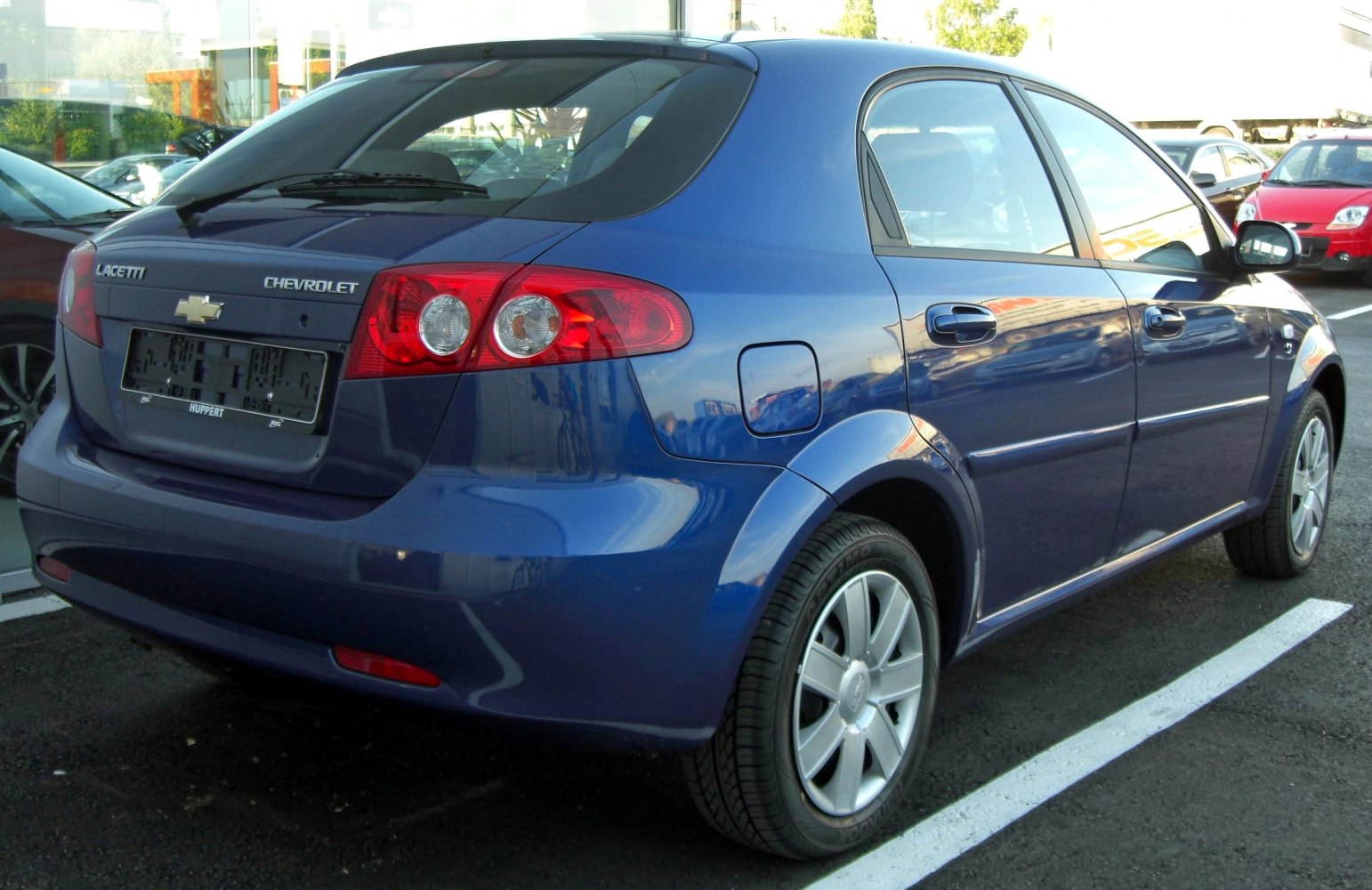 Rear-side view of hatchback with taillights and alloy wheels