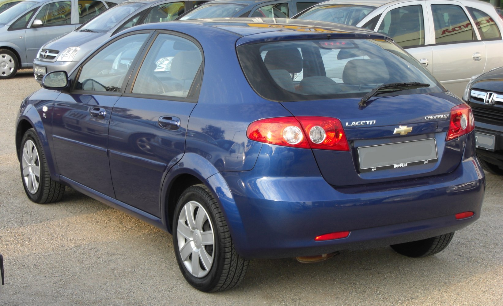 Rear and side view of a hatchback with prominent taillights and alloy wheels