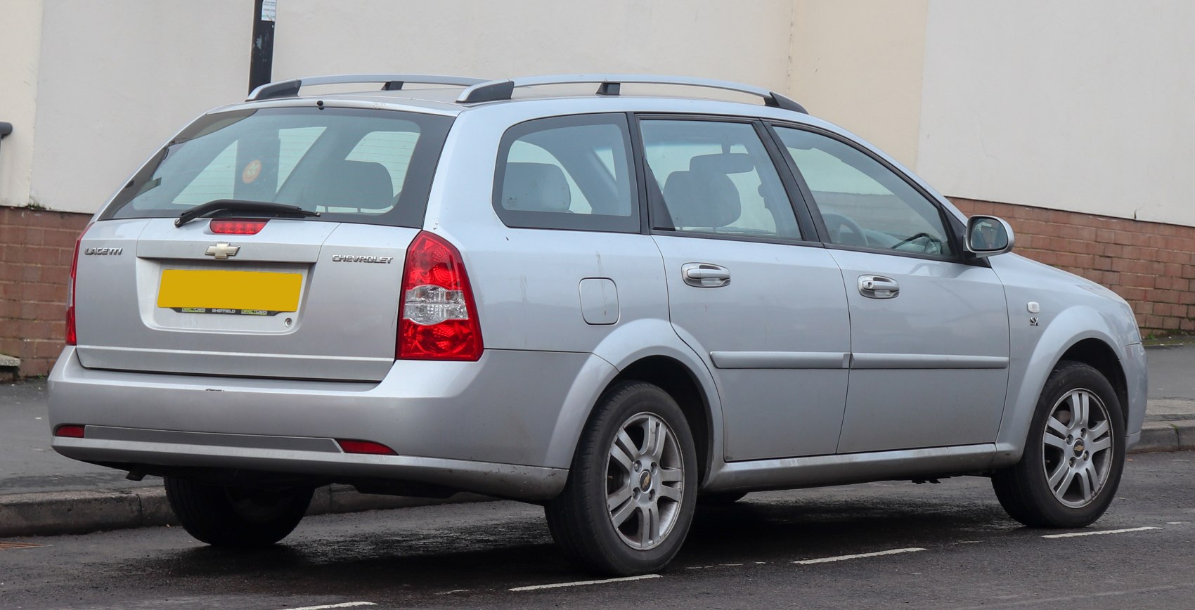 Silver station wagon rear side with roof rails and taillights