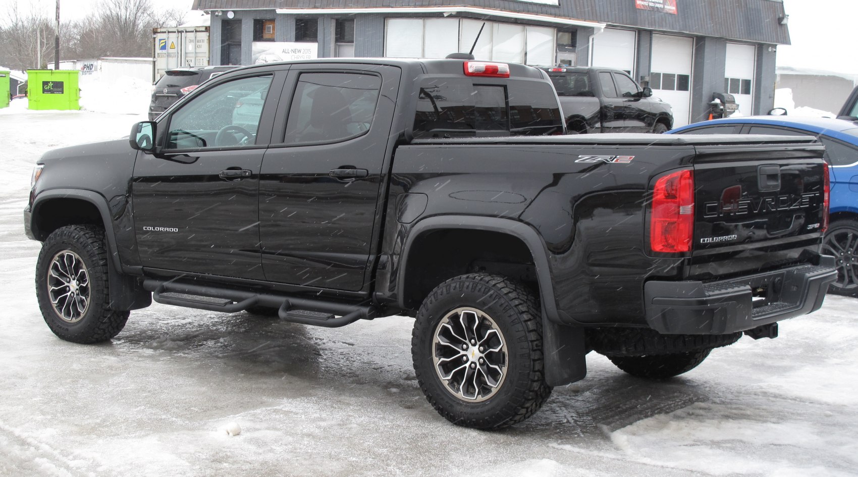 Black Crew Cab Short Box pickup with off-road wheels and lifted suspension