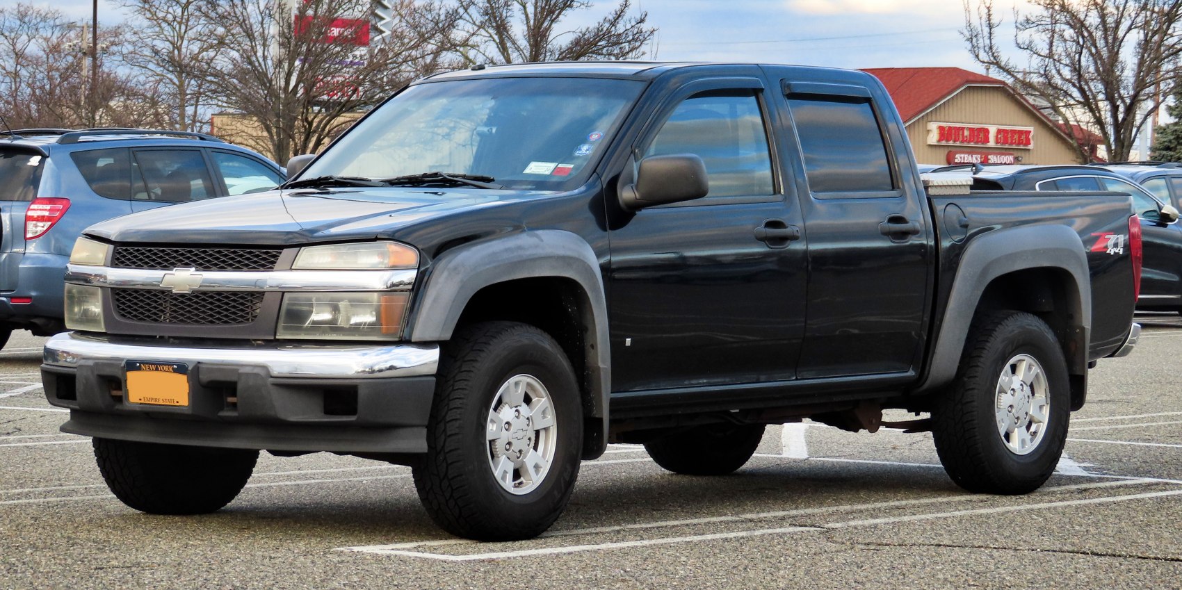 Pickup truck front and side profile with crew cab and 4x4 badge