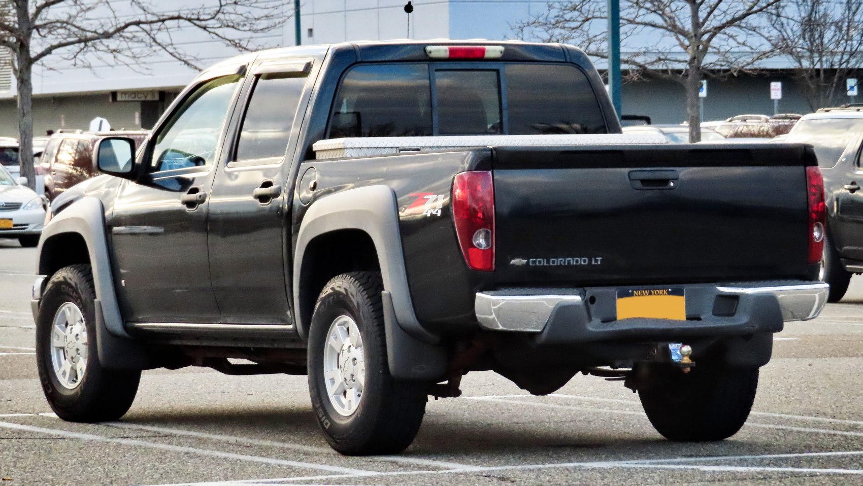 Rear view of Z71 4x4 pickup with bed, tailgate, and alloy wheels