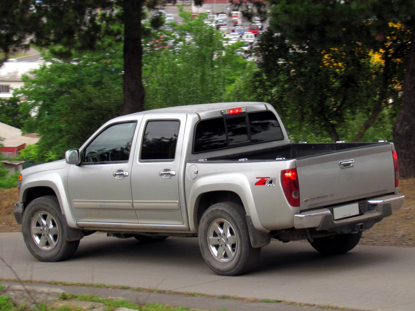 Rear side view of a double cab pickup with truck bed and 4x4 off-road trim