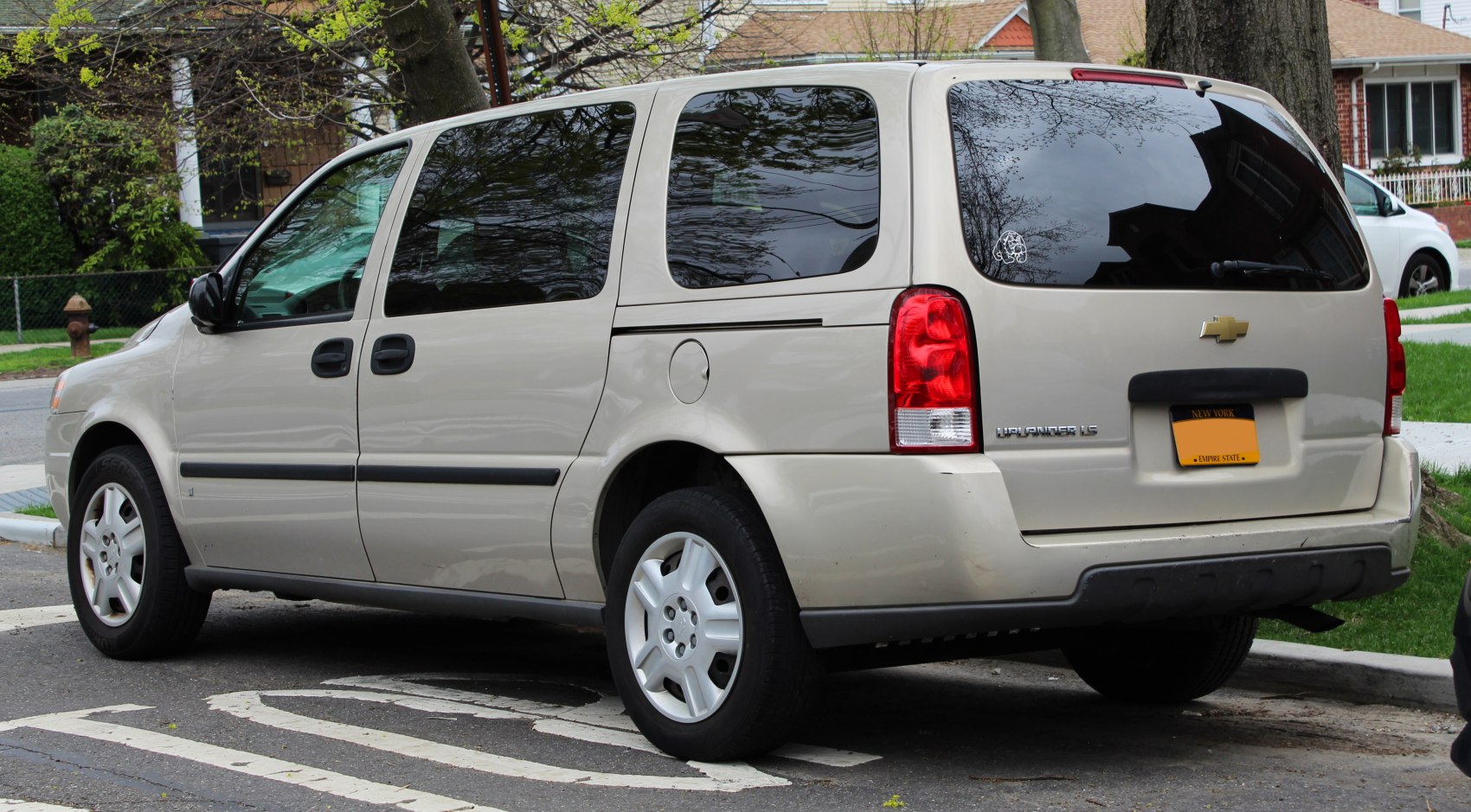 Rear side view of a minivan with sliding doors and tinted windows