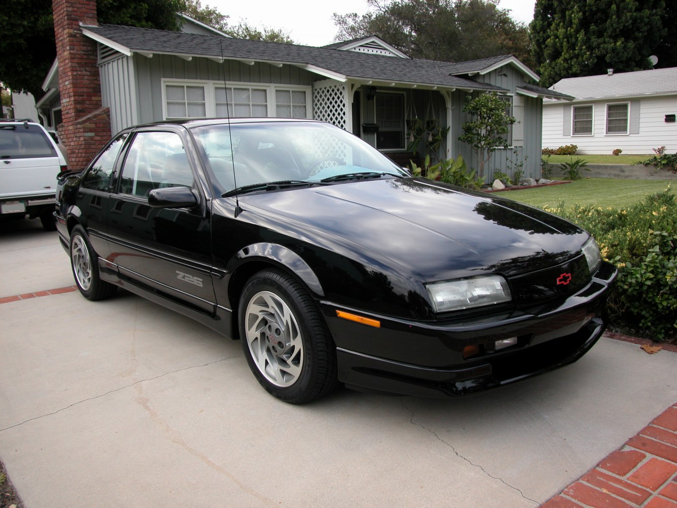 Black 1988 Chevrolet Beretta Z26 front-side view on driveway