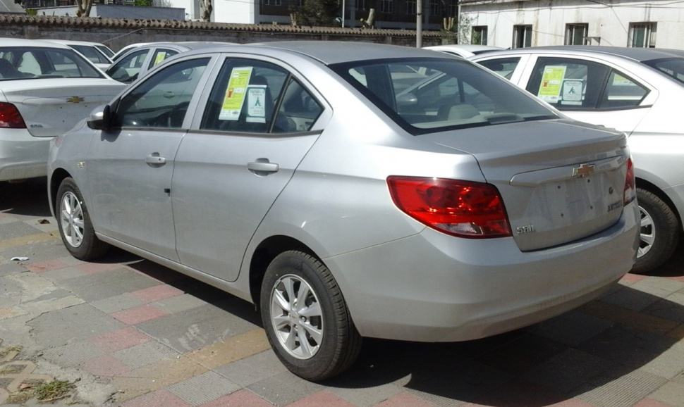 Rear view of a compact sedan with distinctive tail lights and smooth body.