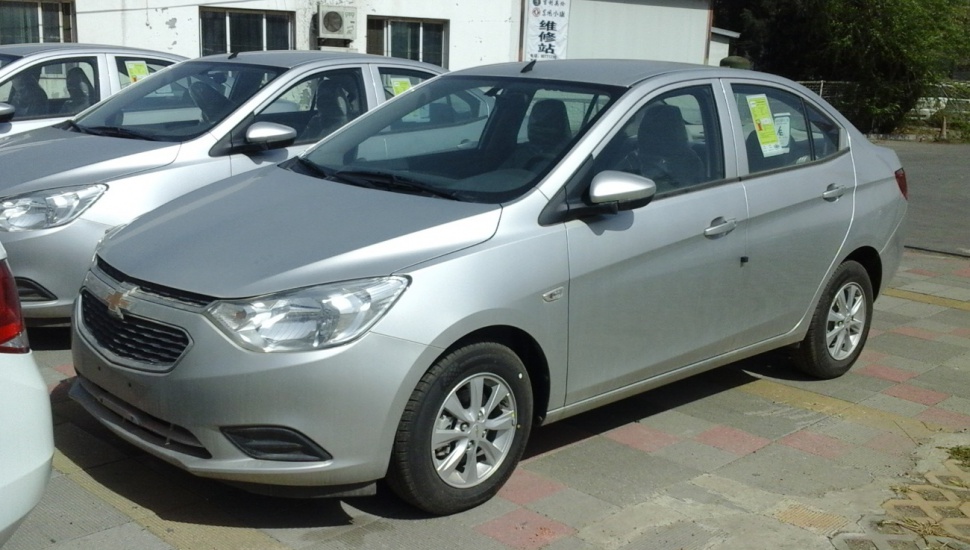 Silver compact sedan with alloy wheels and chrome-accented grille