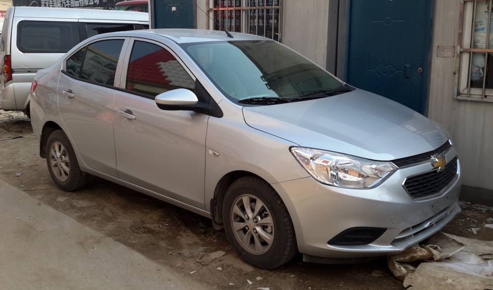 Silver compact sedan front and side view with alloy wheels