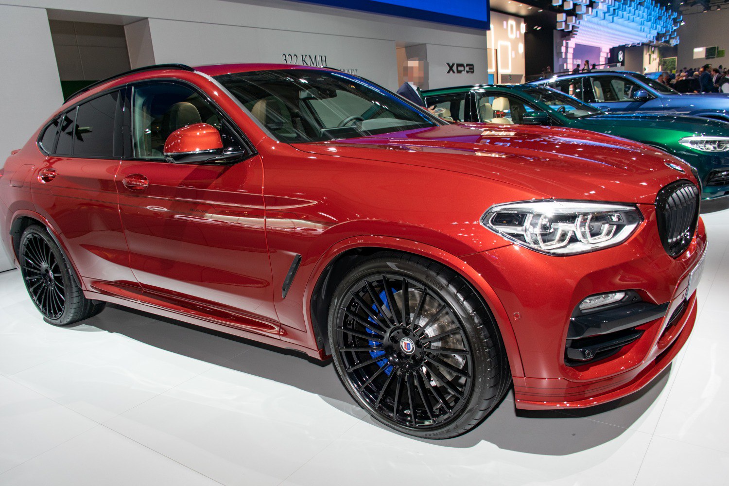 Red luxury SUV with black multi-spoke wheels and LED headlights