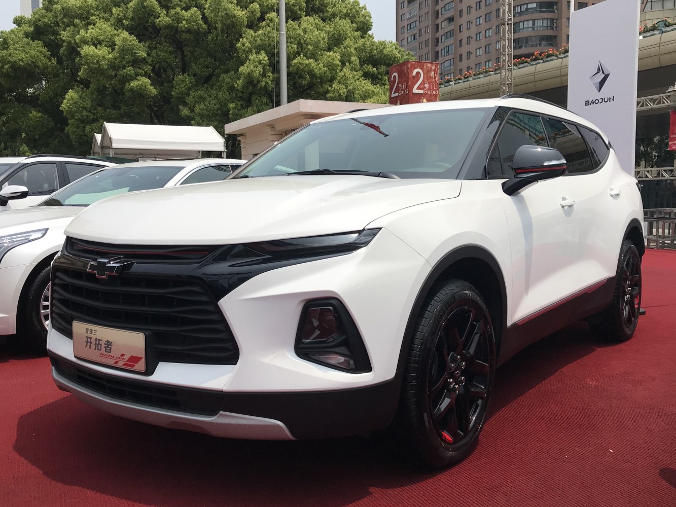 White SUV with aggressive front grille and slim headlights
