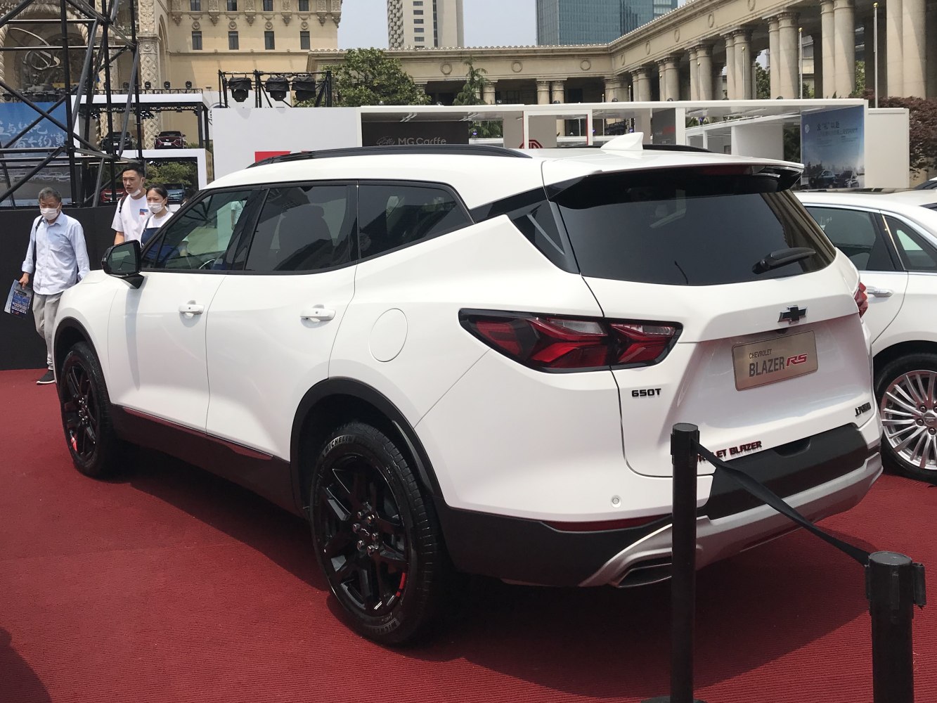 Rear side view of white SUV with black alloy rims