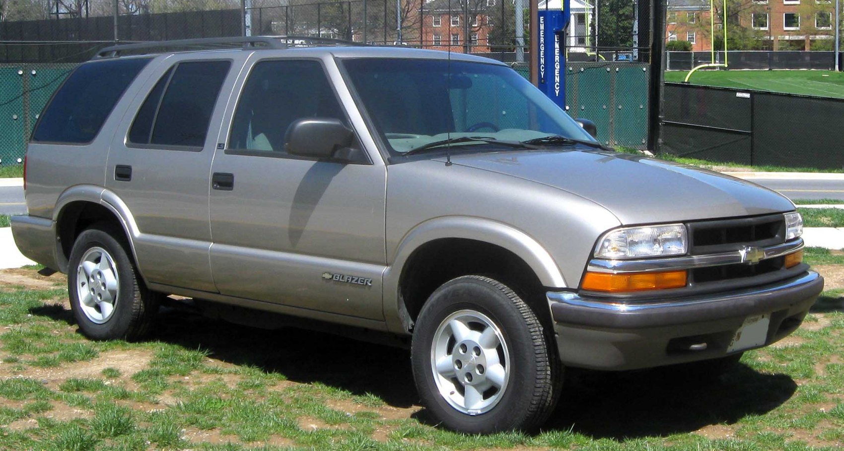 4-door SUV with rounded headlights and alloy wheels on grassy terrain