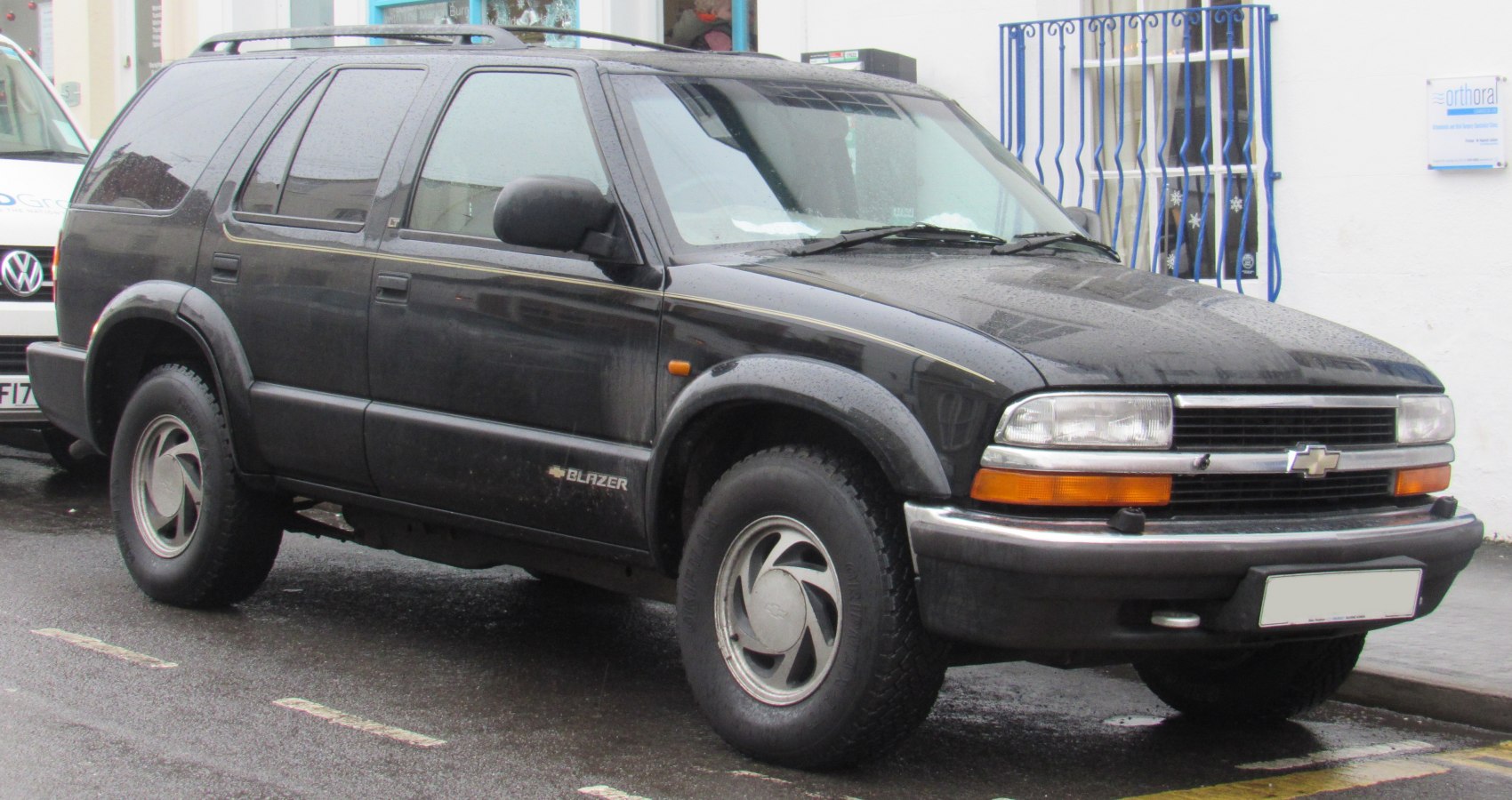 4-door SUV front side view with rugged tires, rectangular headlights, and distinctive grille