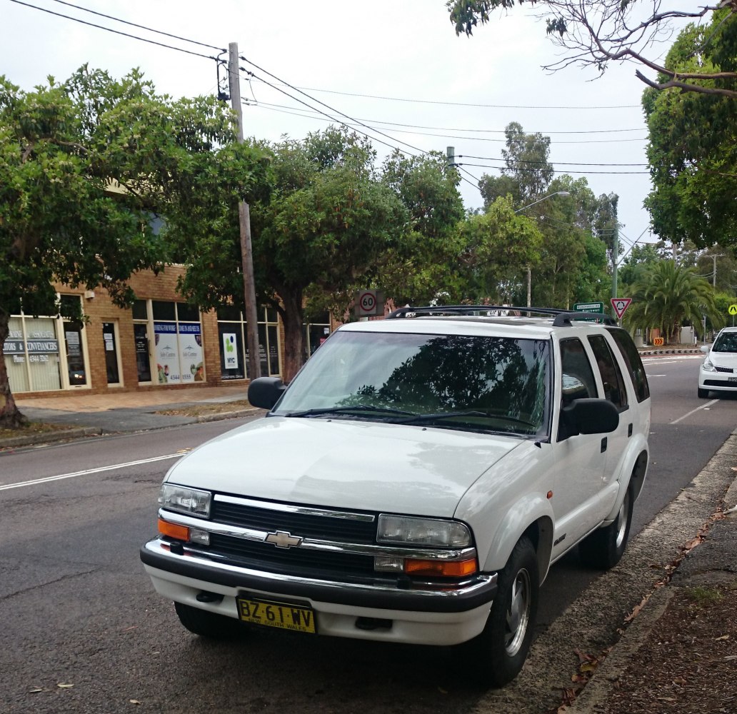 Front view of white 4-door SUV facelift from late 90s