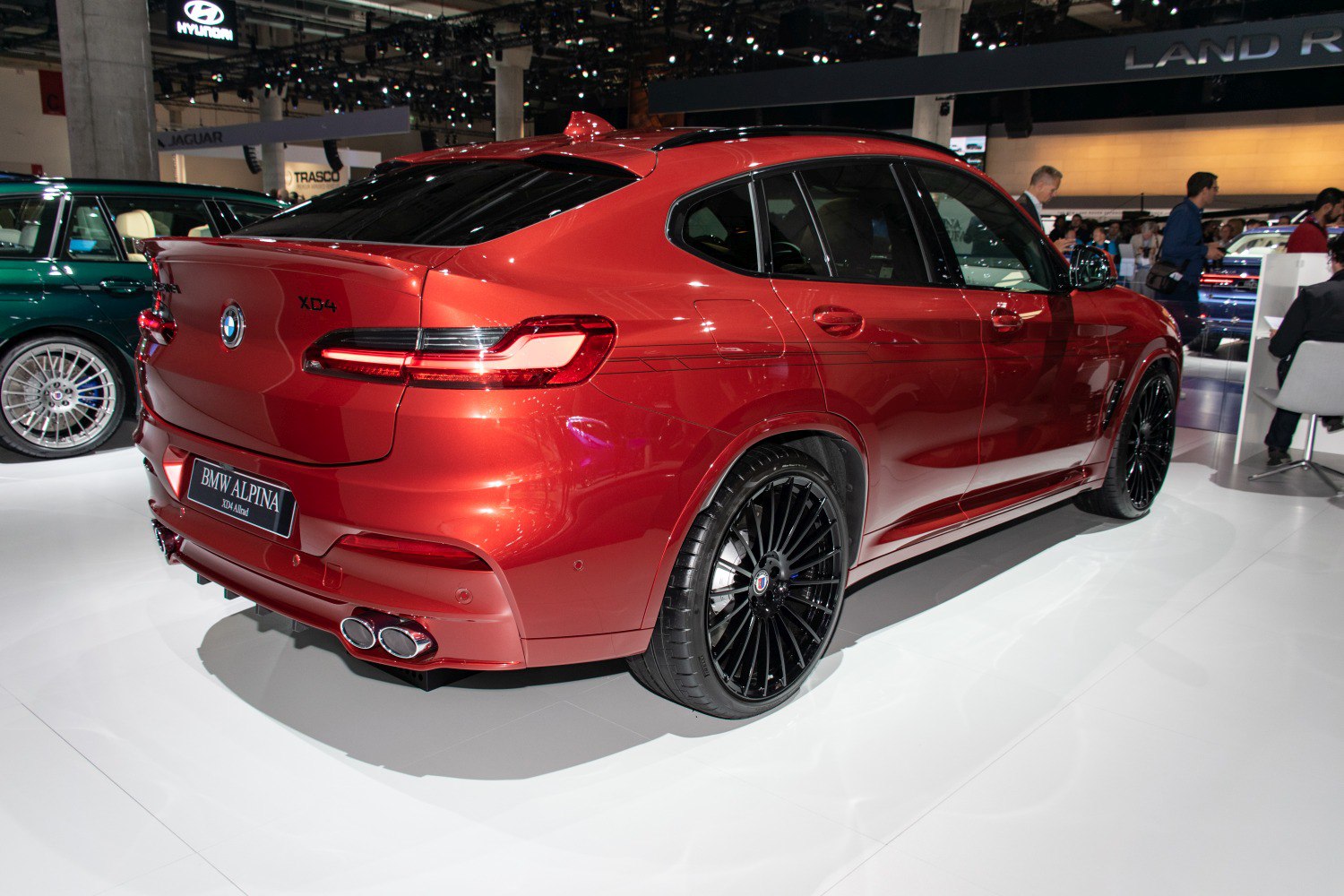 Rear side view with quad exhaust and black multi-spoke wheels