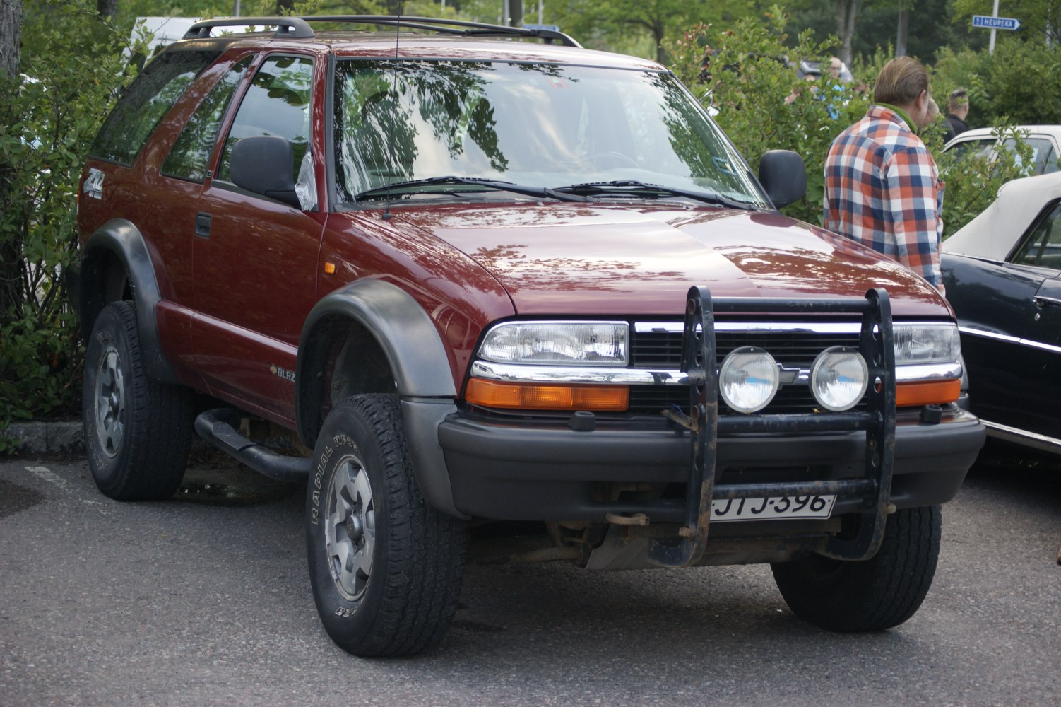 Front angled view of 2-door SUV with bull bar and roof rack