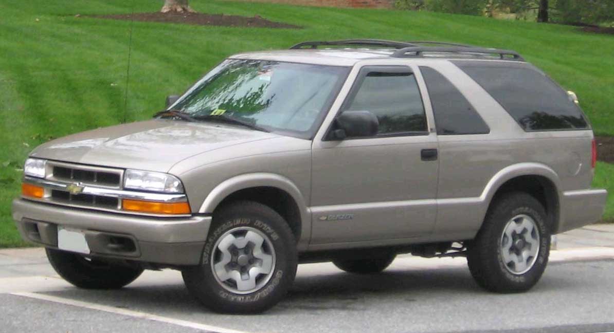 2-door SUV with roof rack and distinctive front grille design