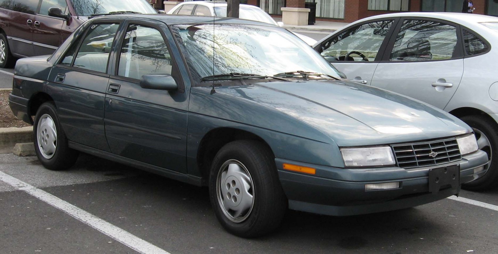 Front-side angle of 1987 sedan with rectangular headlights and alloy wheels