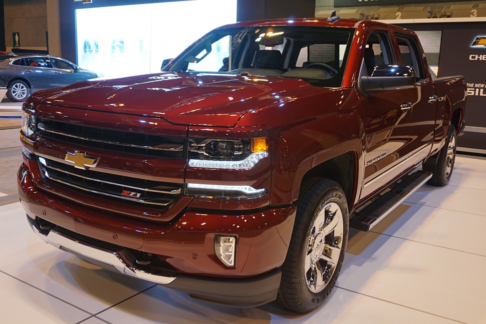 Front view of a modern truck with grille, headlights, and chrome rims.