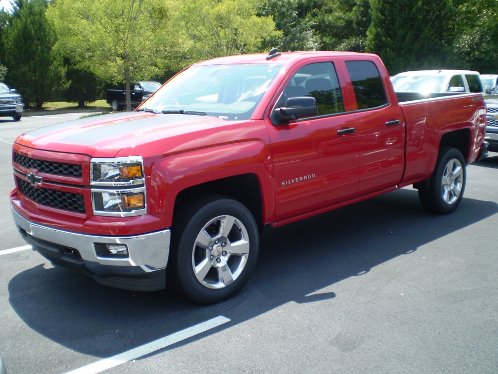 Red double cab pickup with chrome grille and alloy wheels